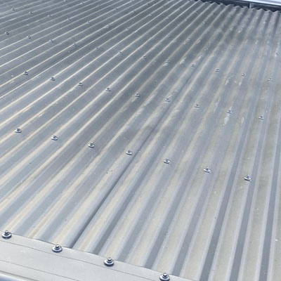 Patchy roof weathering aligned with water flow paths