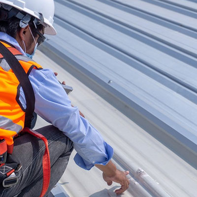 Assessment of coating wear patterns indicating progressive roof issues