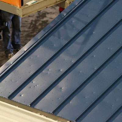 Shallow hail dents on metal roof without coating damage