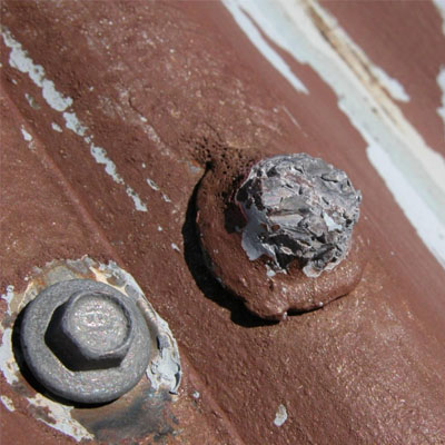 Corroded roof fasteners indicating concealed maintenance risk